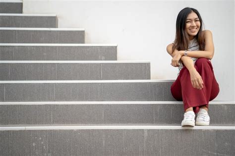 Premium Photo Low Angle Portrait Of Smiling Mid Adult Woman Sitting