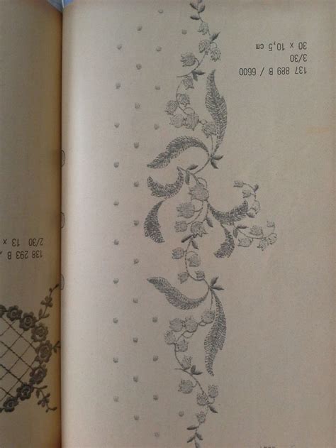 An Open Book With Embroidered Designs On The Pages And Numbers Written