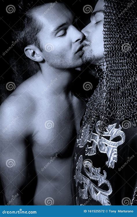 Gay Lovers Couple With A Shirtless Man And Knight In Full Armour Kissing Stock Photo Image