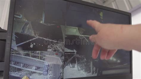 Male Caucasian Hand Pointing At Security Cameras On Computer Screen At