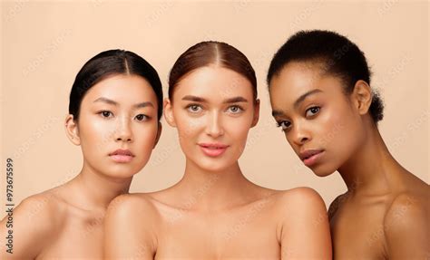 Female Beauty Three Multiracial Models Girls Looking At Camera Posing Naked On White Background