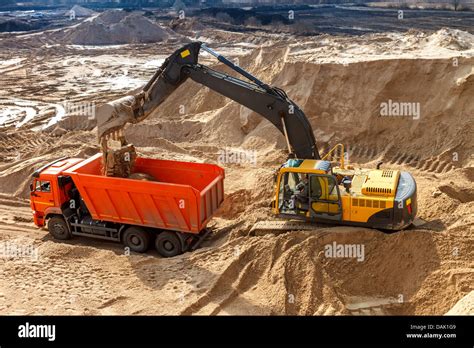 Excavator Loading Dumper Truck At Construction Site Stock Photo Alamy