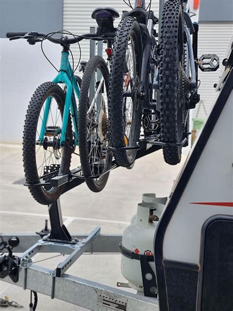 A Bicycle Is Attached To The Back Of A Trailer