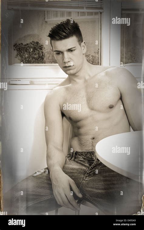 Sad Pensive Lonely Guy In Jeans With Naked Chest Sitting Thoughtful Stock Photo Alamy
