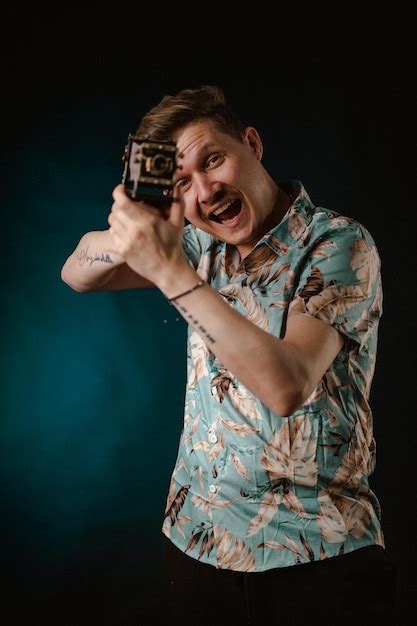 Premium Photo | A man holding a gun with a tattoo on his shirt