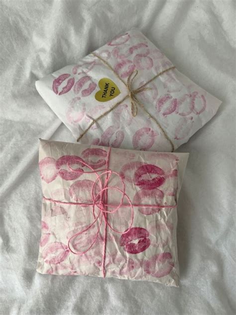 Two Pillows With Pink And White Designs On Them