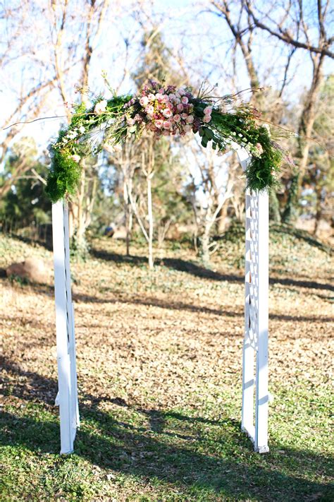 White Wedding Arch with Green and Pink Floral Decor