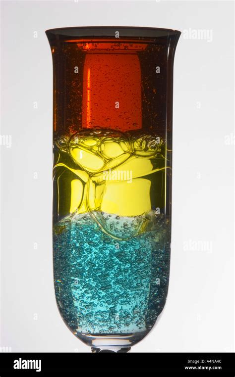 Three Layers Of Different Density Liquids In Small Cordial Glass Stock