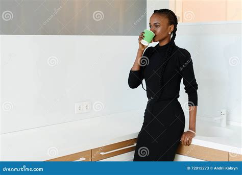 Candid Image Of A Businesswoman Drinking Coffee While Working At Light