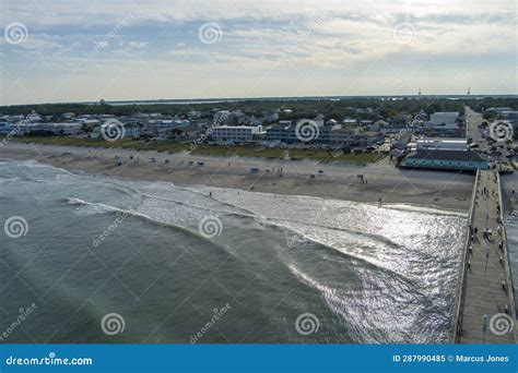 Aerial Shot Of The Kure Beach Pier With Ocean Water Waves People On