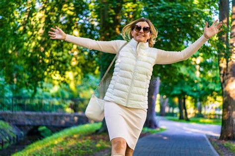 Beautiful Mature Woman Walking In City Park Stock Photo Image Of Leaves Beautiful