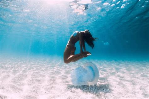 Naked Woman Free Diver Glides Over Sandy Sea With Fins Freedivi