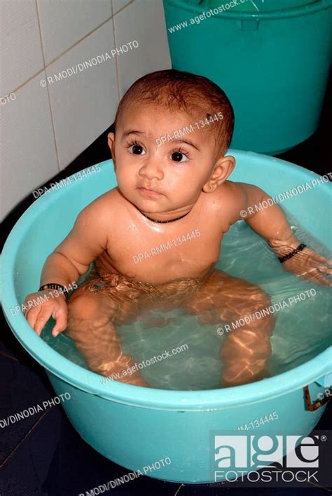 Indian Nude Baby Girl Bathing Sitting In Plastic Tub India MR Stock Photo Picture And