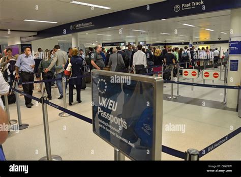 Crowded arrivals hall, North Terminal, London Gatwick Airport, Crawley, West Sussex, England ...