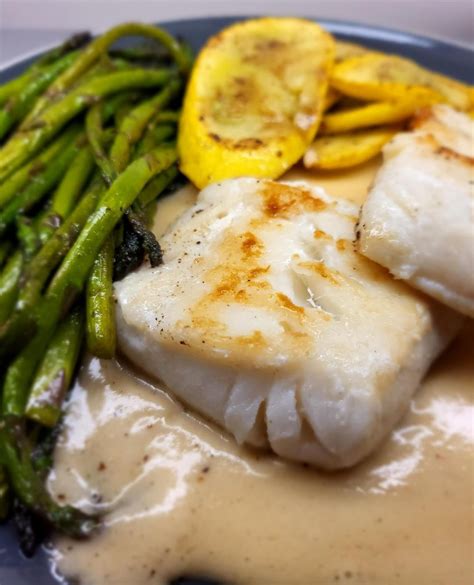 Pan Seared Pacific Cod Over Beurre Blanc Sauce With Asparagus And