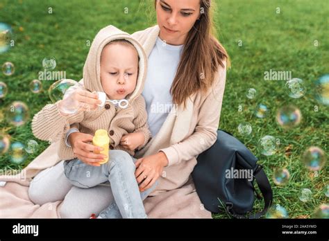 Little Boy Inflates Air Bubbles Woman Mom Plays With Child Summer