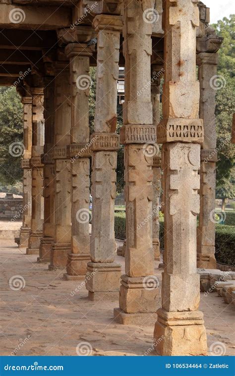 Columns With Stone Carving In Courtyard Of Quwwat Ul Islam Mosque