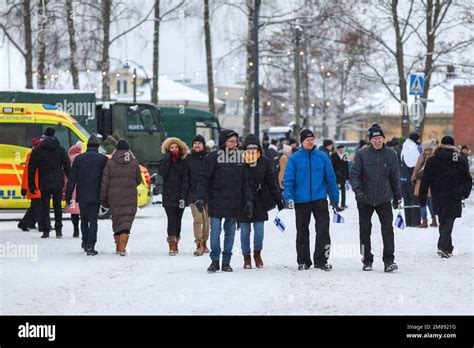 People with Finnish flags walk down the street during the Independence ...