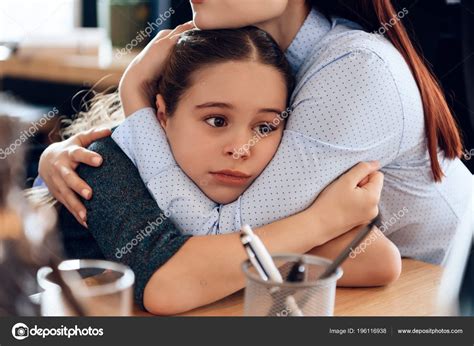 Mother And Daughter Hugging Sad