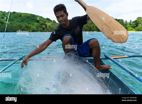 Young Filipino Fisherman Preparing Fishing Net On His Boat Philippines