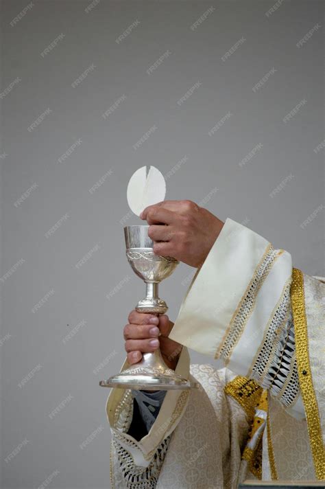 Premium Photo Priest Holding A Chalice And Communion Bread Stock Photo