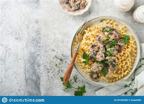 Fusilli Pasta With Mushrooms Cheese And Garlic Creamy Sauce On Plate