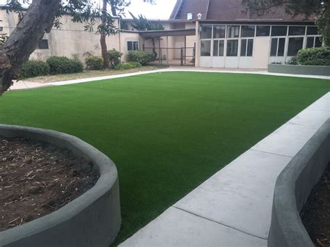 Artificial Turf Installation Court Yard Covered With Lush Green Turf And Surrounded By Concrete