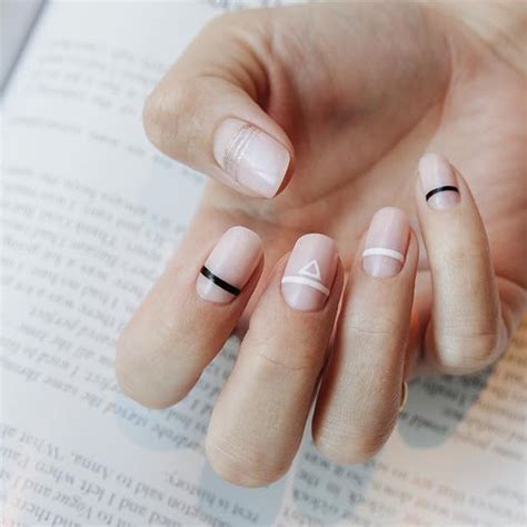 A Woman S Hand With French Manies And A Ring On Her Finger Is Shown In