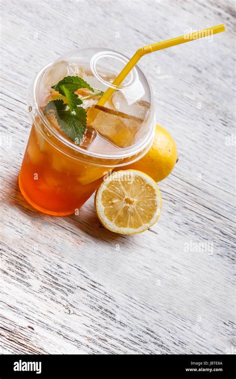 Iced Tea In Plastic Cup With Lemon And Mint Stock Photo Alamy