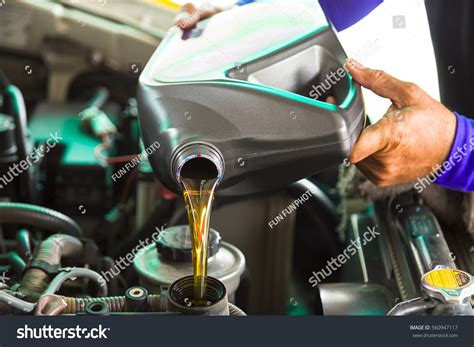 Car Mechanic Replacing Pouring Fresh Oil Stock Photo 560947117