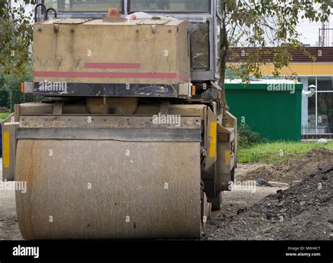 Workers Operating Asphalt Paver Machines And Tippers During Road