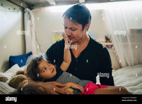 Mature Father And Playful Daughter Bonding While Sitting In Bedroom Stock Photo Alamy