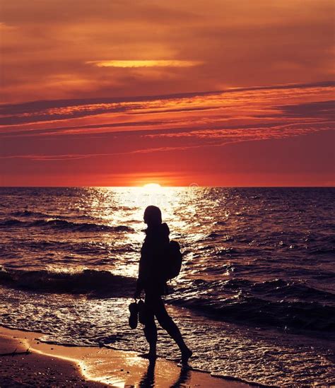 Woman Walking On The Beach At Sunset Backlight Stock Photo Image Of