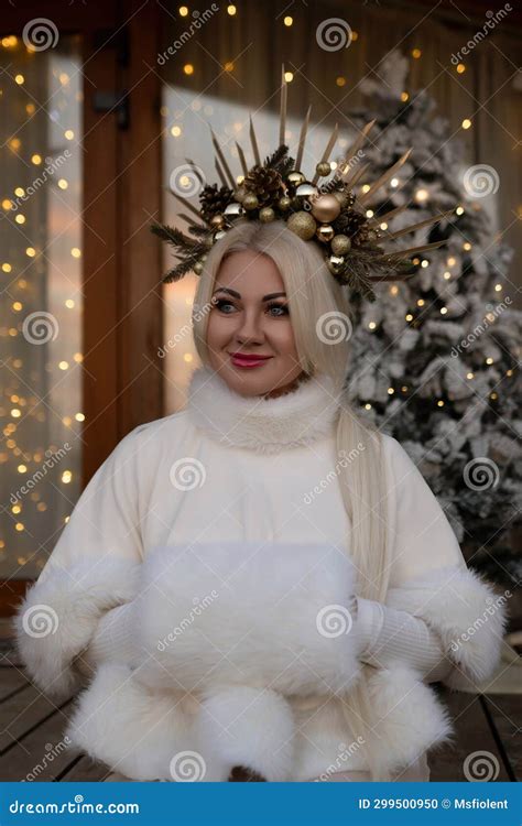 Happy Blonde As Snow Maiden In White Costume Wooden House Exterior Festive Setting Stock Photo