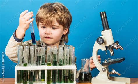 Boy scientist in laboratory. Cute kid making science experiment. Little ...