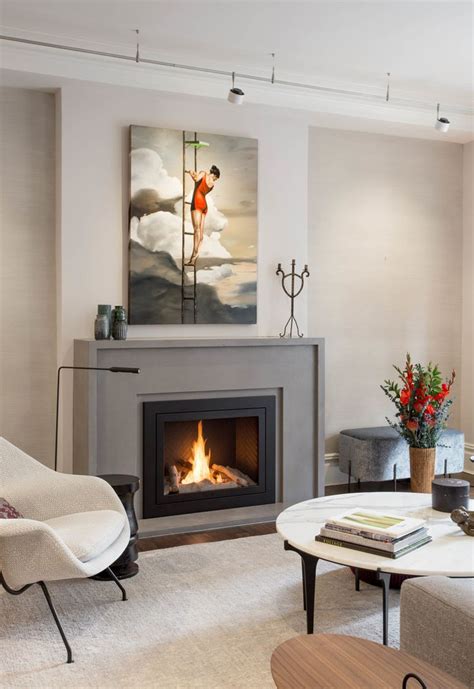 A Living Room Filled With Furniture And A Fire Place Next To A Painting