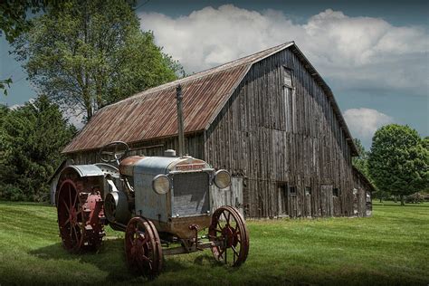 Vintage Mccormick Deering Tractor With Old Weathed Barn In A Rus