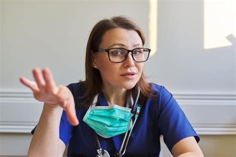 Premium Photo Portrait Of Talking Doctor Woman In Blue Uniform With