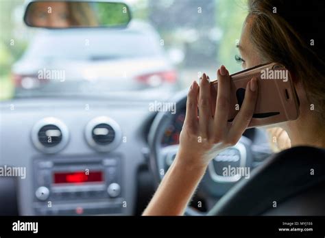 Woman Driving Whilst Using Mobile Phone Stock Photo Alamy