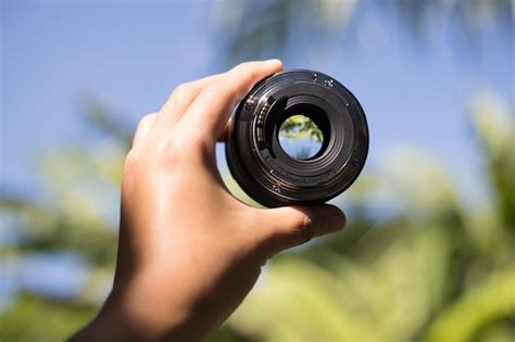 Premium Photo Cropped Hand Holding Camera Lens