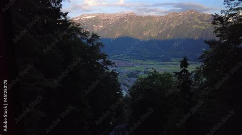 Red Funicular Train Driving Downhill From Harder Kulm Top Of