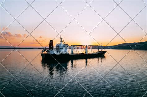 Aerial View Cargo Ship Waiting to Enter the Port - Photos by Canva