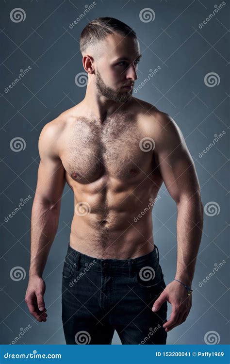 Muscular Shirtless Man Standing With Hands In Pockets Stock Image