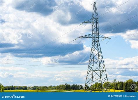 Power Transmission Lines And Tall Electricity Pylon Against The Blue