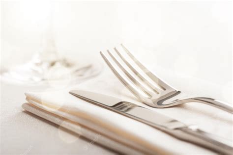 Premium Photo | Table setting with fork and knife on napkin