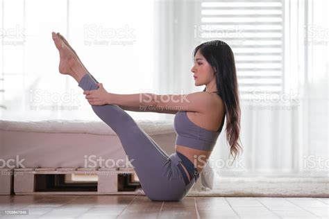 Attractive Asian Woman Practice Yoga Boat Pose Or Navasana Pose To