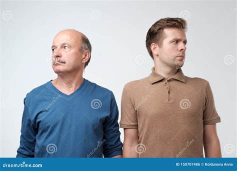 Mature Father And Son Being In Quarrel Looking Aside Stock Photo Image Of Offended People