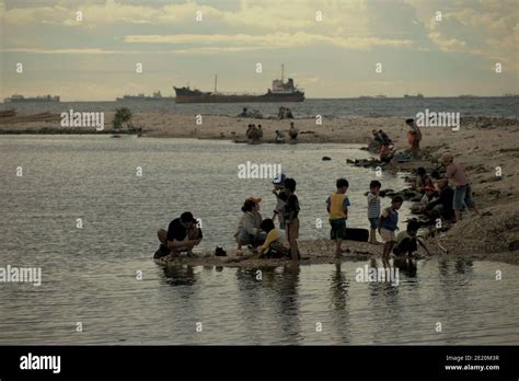 People having recreational activities on Cilincing beach, on the coastal area of Jakarta ...