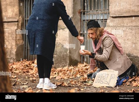 People Giving Money To The Poor