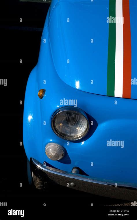 An Italian Flag Stripe On The Front Of A Classic Blue Fiat Car At A